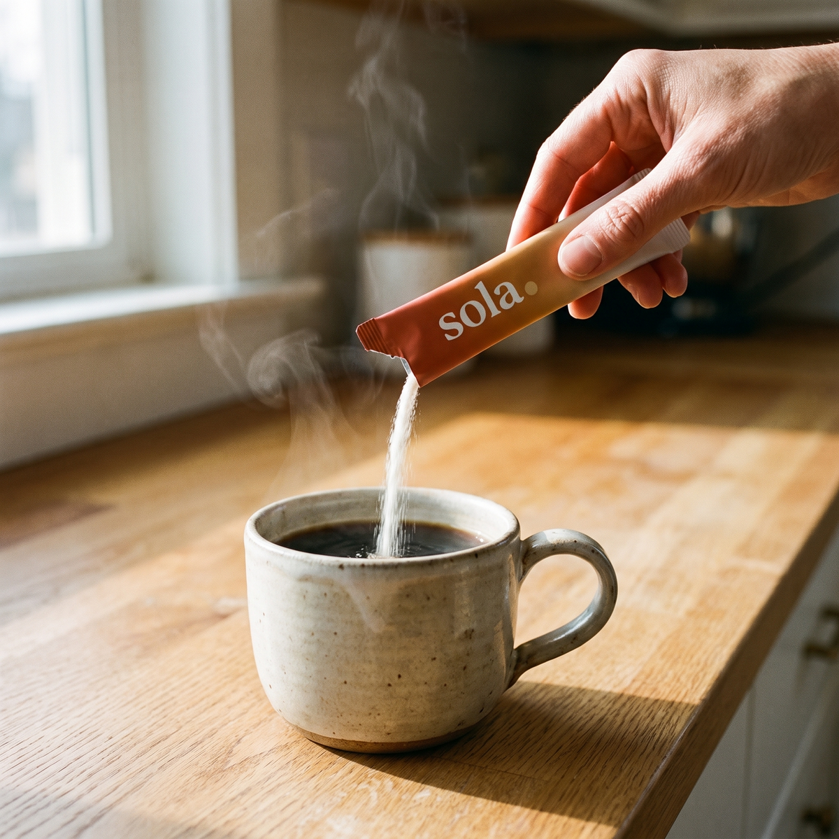 Pouring a Sola stick pack into a mug of black coffee